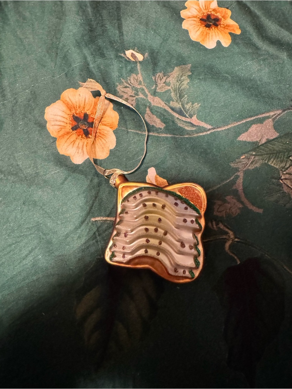 Gold Wave Glass Ornament with Green and White Accents